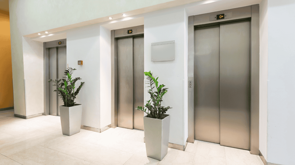 Three sets of elevators at a corporate office.