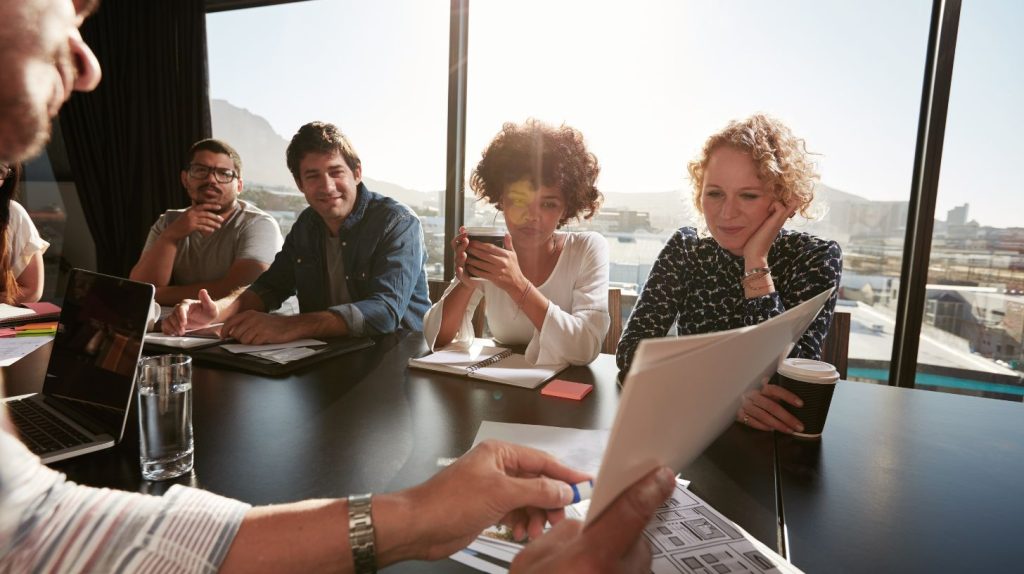 Executive presenting a proposal from a leading executive search firm to their team.
