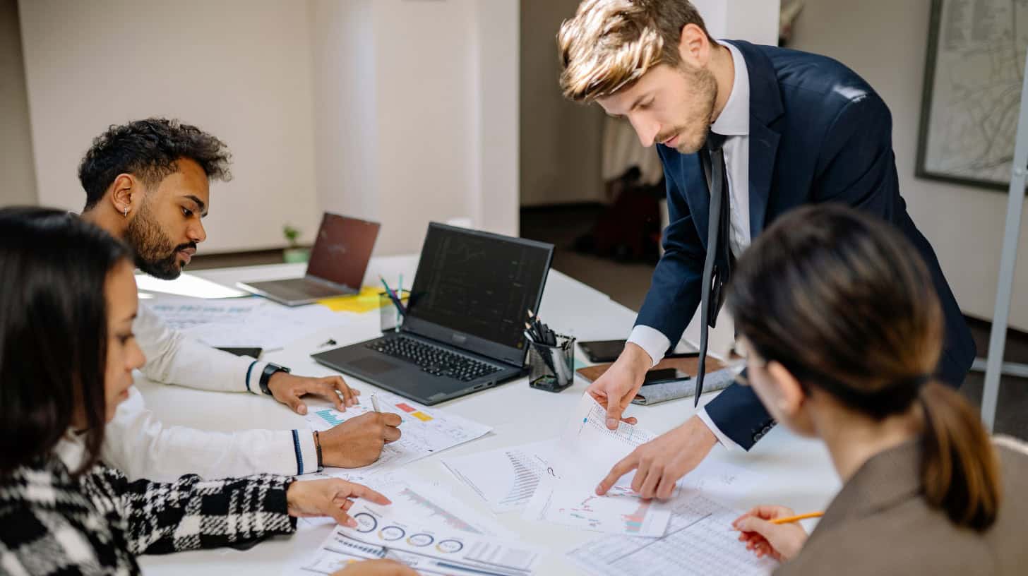 Chief Financial Officer placed by a financial services executive search firm reviews financial data with his team.