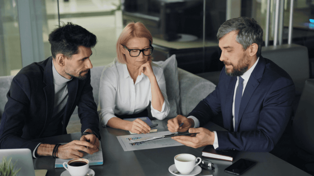 Three executives meeting to discuss whether to hire a boutique executive search firm.