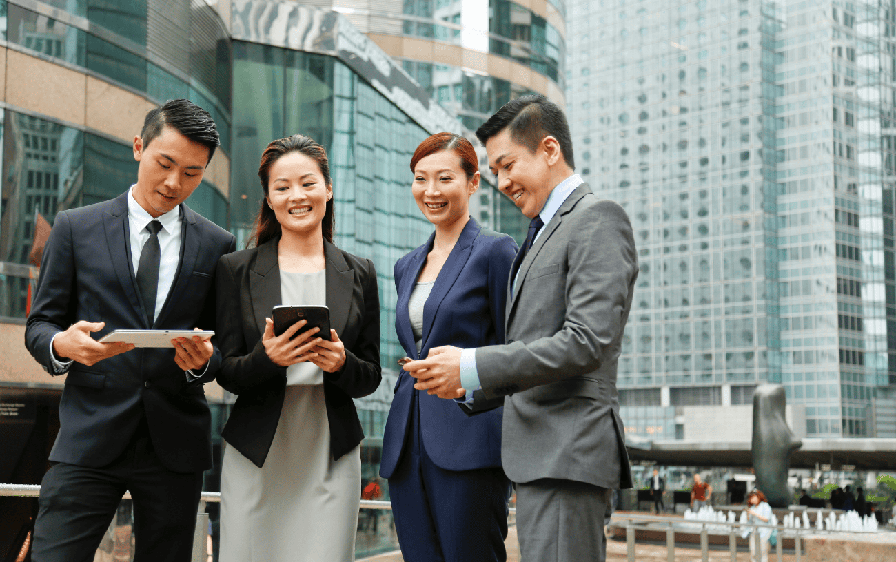 Technology executives checking devices.