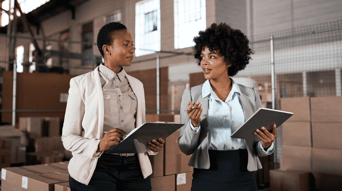 Chief Operating Officer and operations executive conducting a supply chain review in a warehouse, illustrating modern operational leadership.
