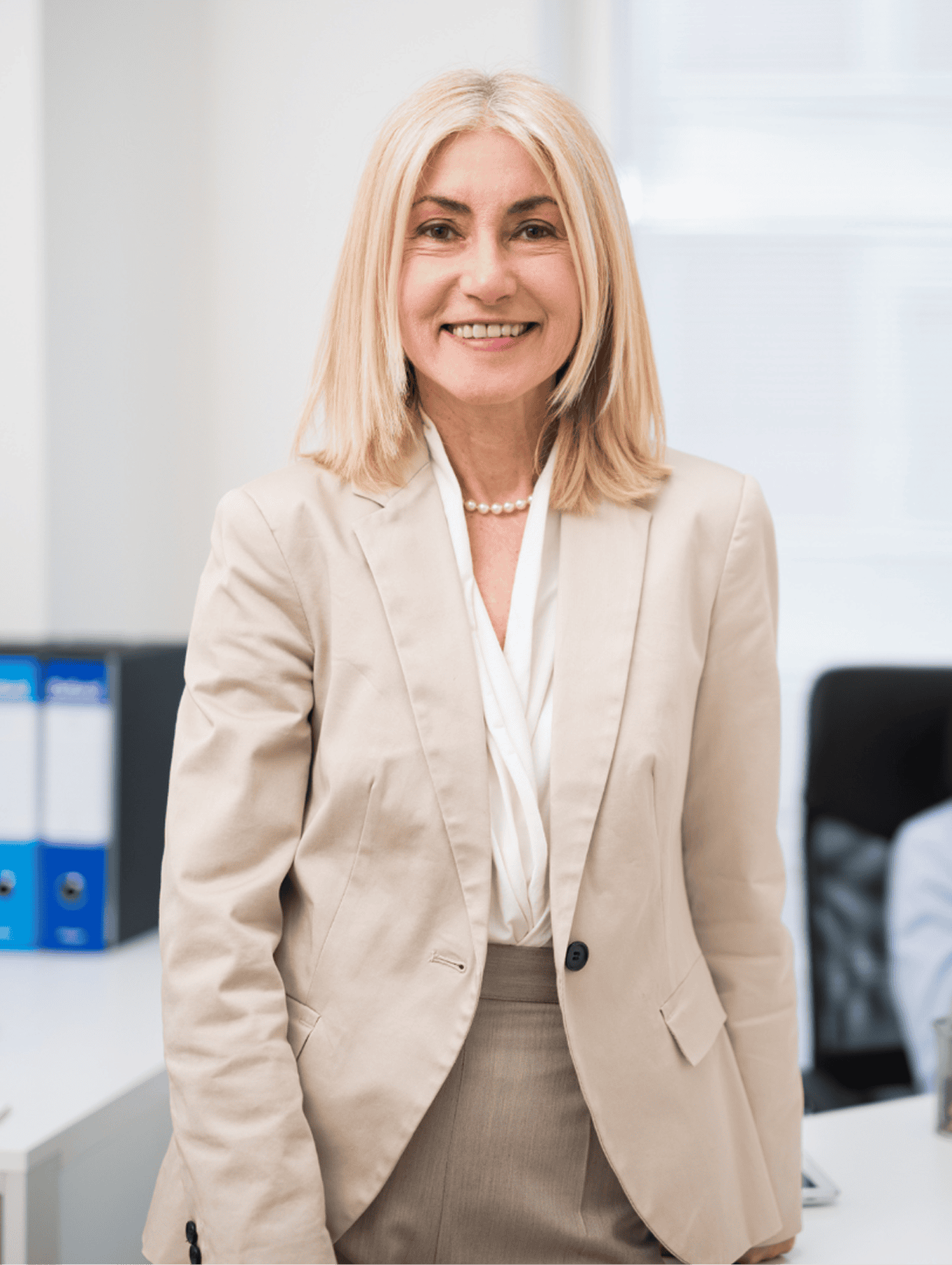 Chief Corporate Affairs Officer smiling in her office.