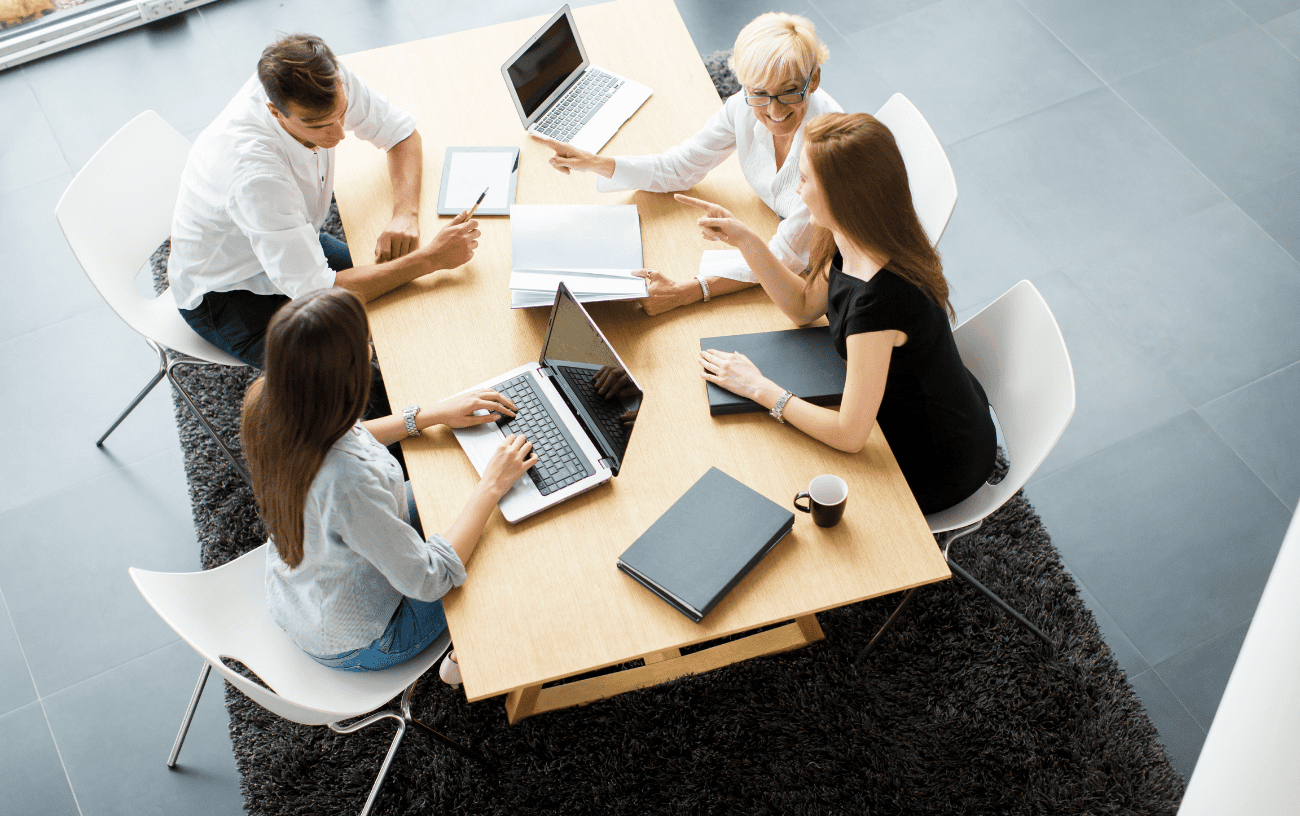 Legal, risk, and compliance meeting around a conference table.
