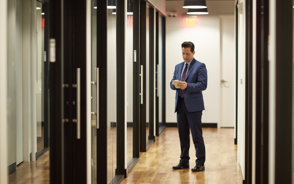 A product executive standing in the hallway before his next product review meeting.