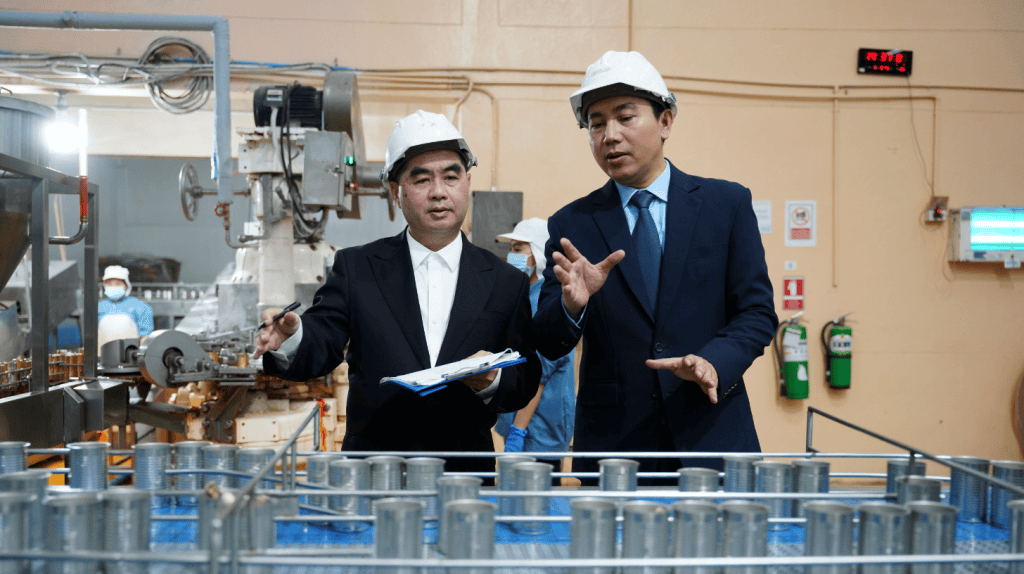 Chief Product Officer walking a manufacturing floor with a plant manager, reviewing operational strategy firsthand.