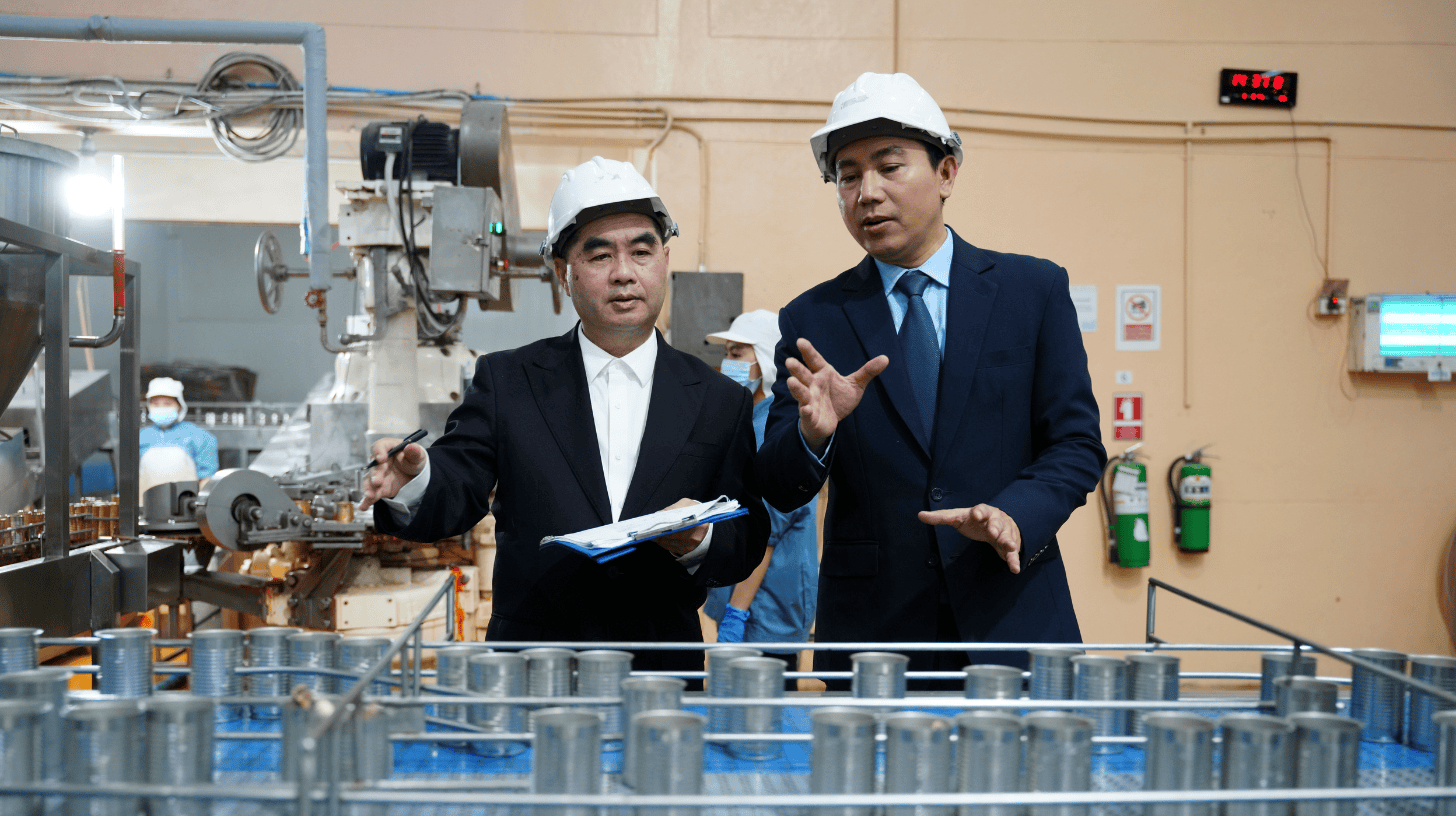 Chief Product Officer walking a manufacturing floor with a plant manager, reviewing operational strategy firsthand.