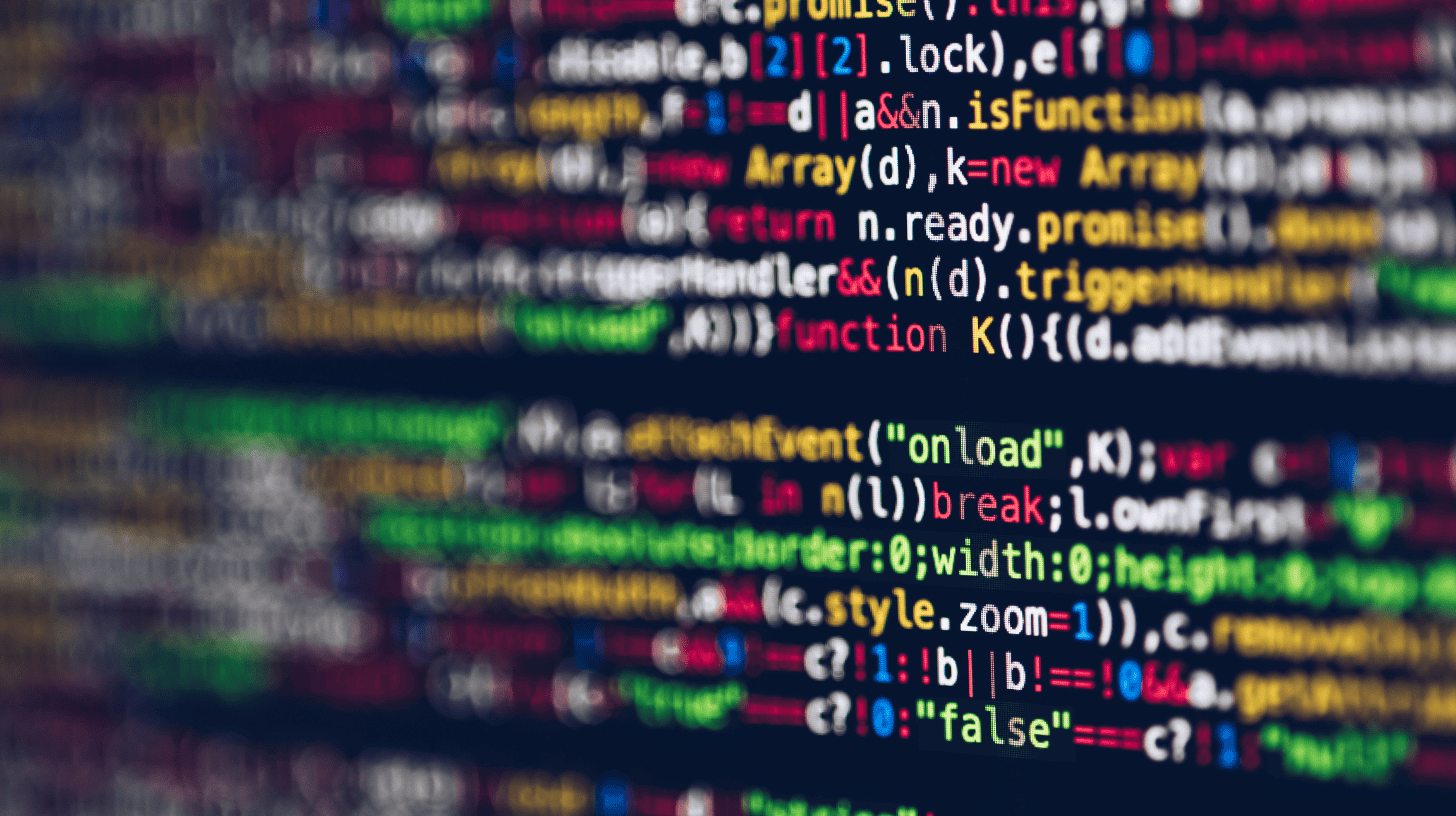 Colorful code on a dark screen representing the technical complexity driving demand for technology executive search.