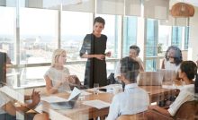C-suite leader presenting to a boardroom team on how private equity executive search drives leadership alignment and value creation.