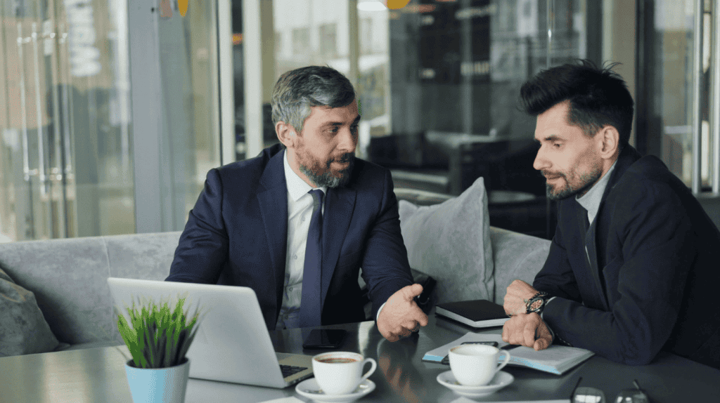 Senior executive discussing leadership development with a colleague during an executive coaching conversation.