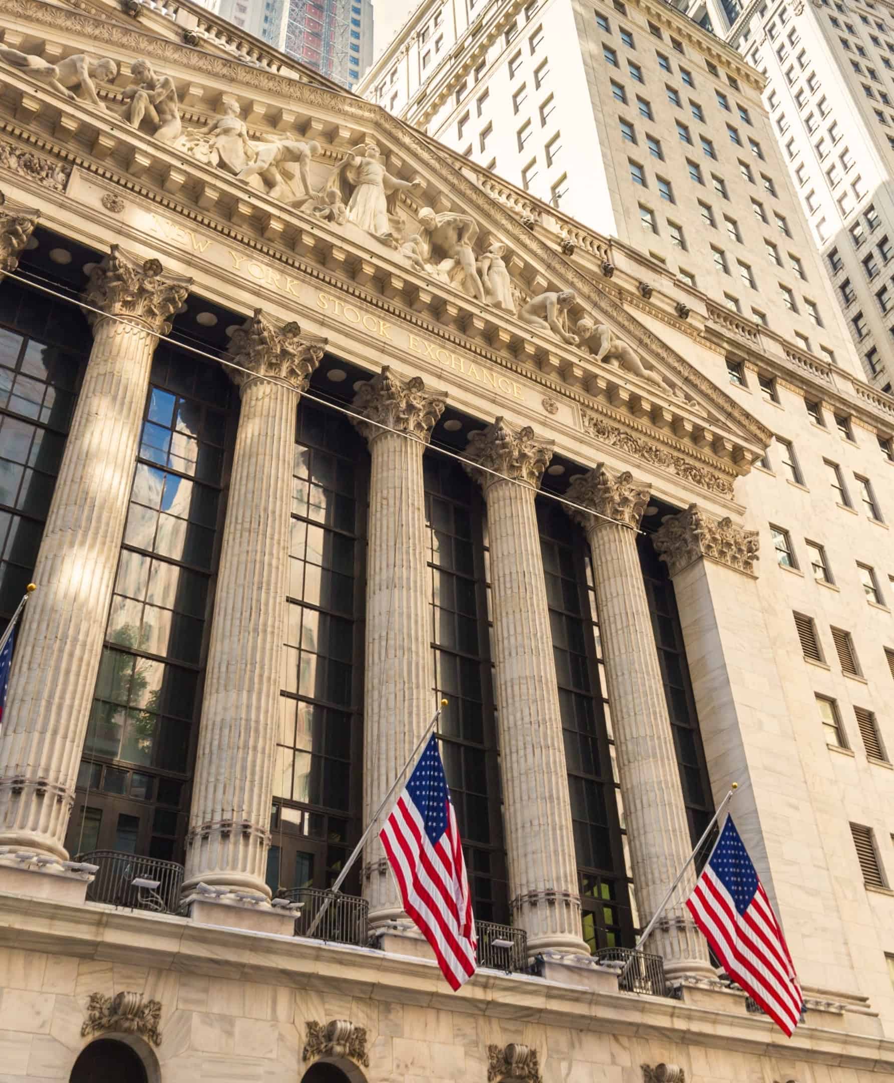 Fachada de la Bolsa de Nueva York con banderas estadounidenses en el sector de los mercados de capitales.