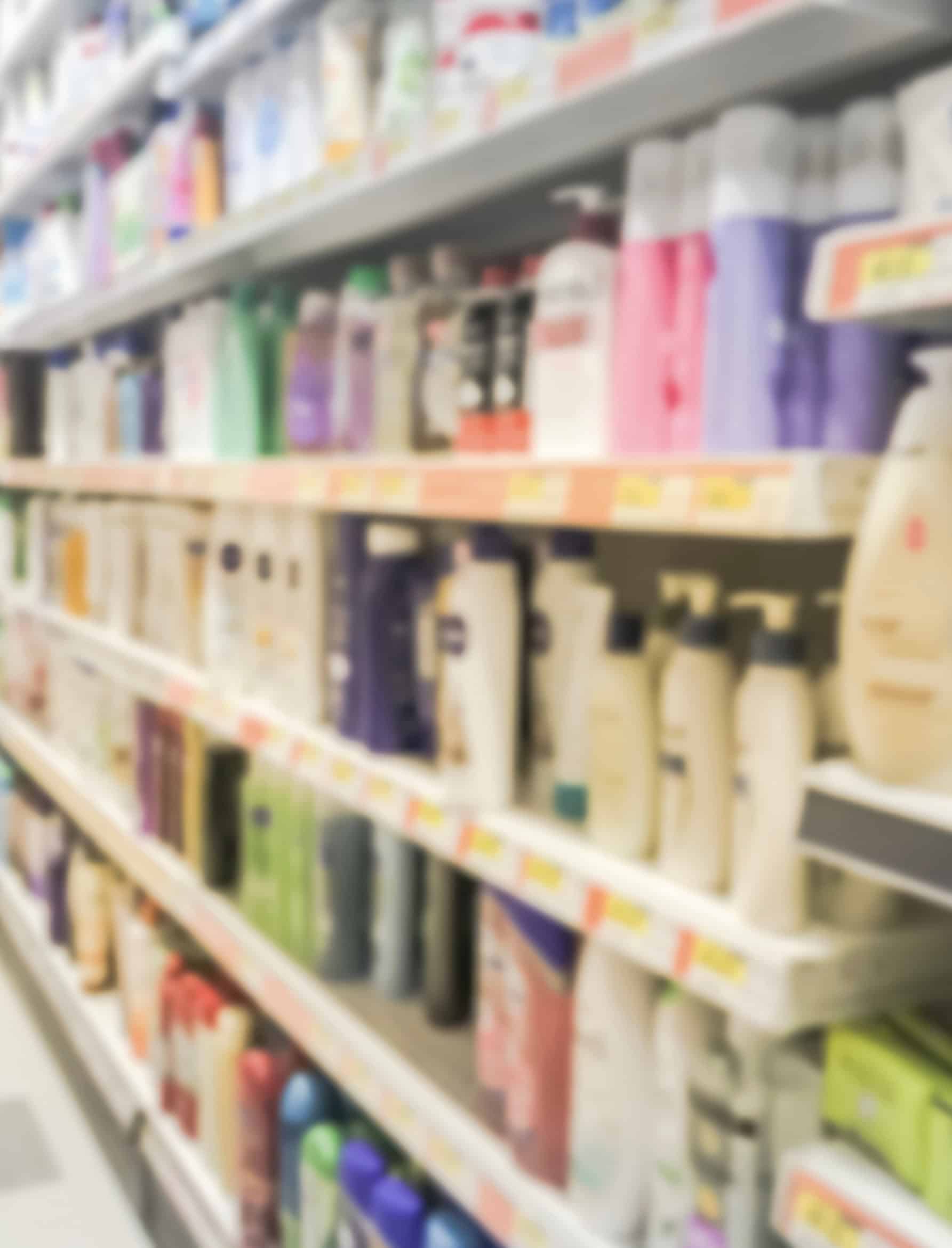 Supermarket aisle stocked with consumer packaged goods on retail shelves.