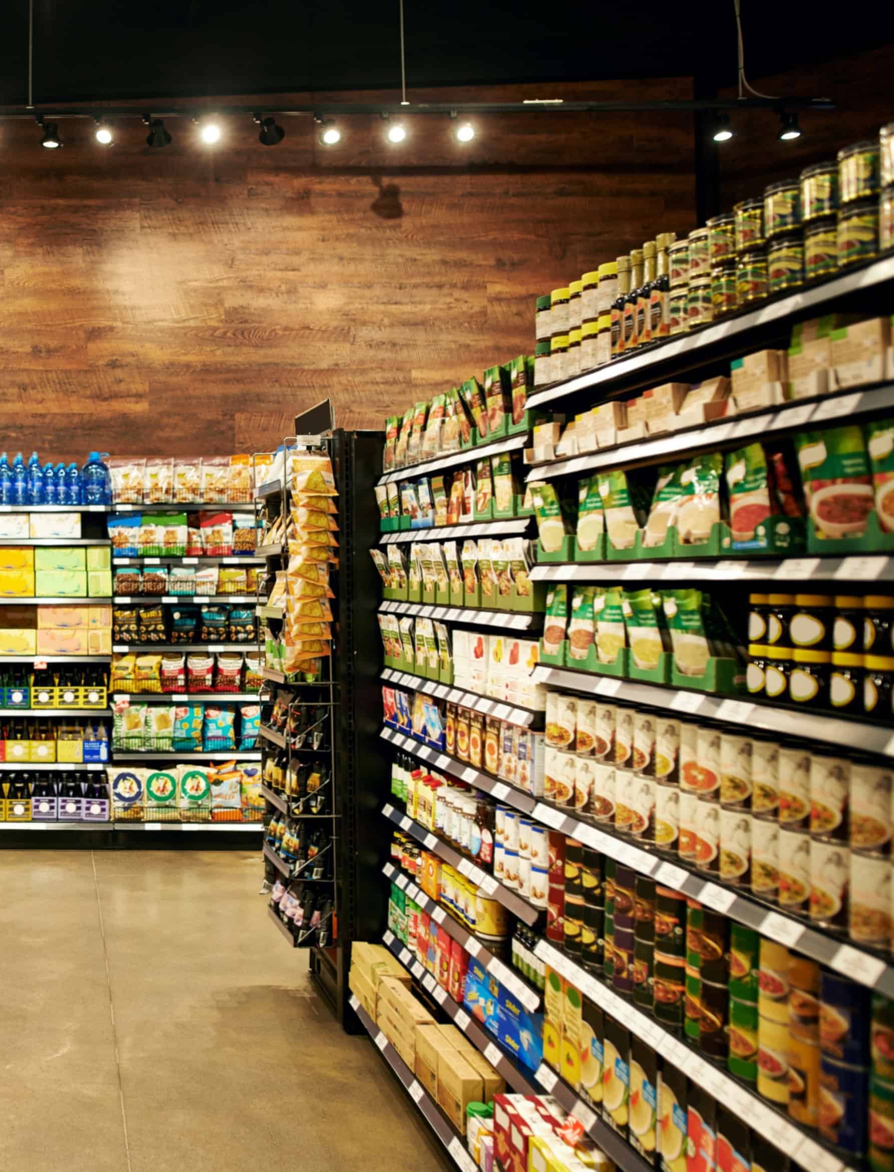 Grocery store aisle stocked with packaged food and beverage consumer products.