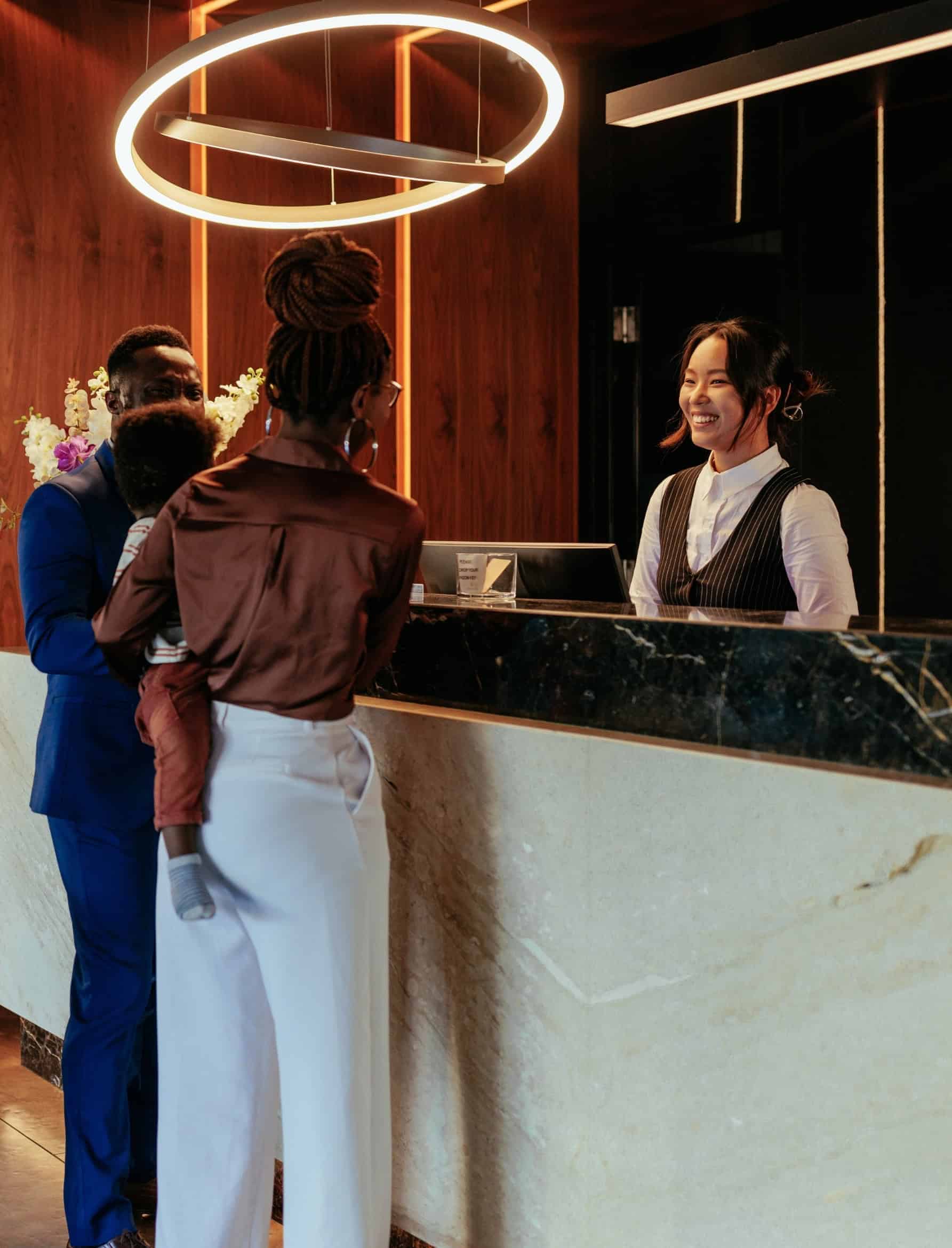 Family checking in at a luxury hotel front desk in the hotel industry.