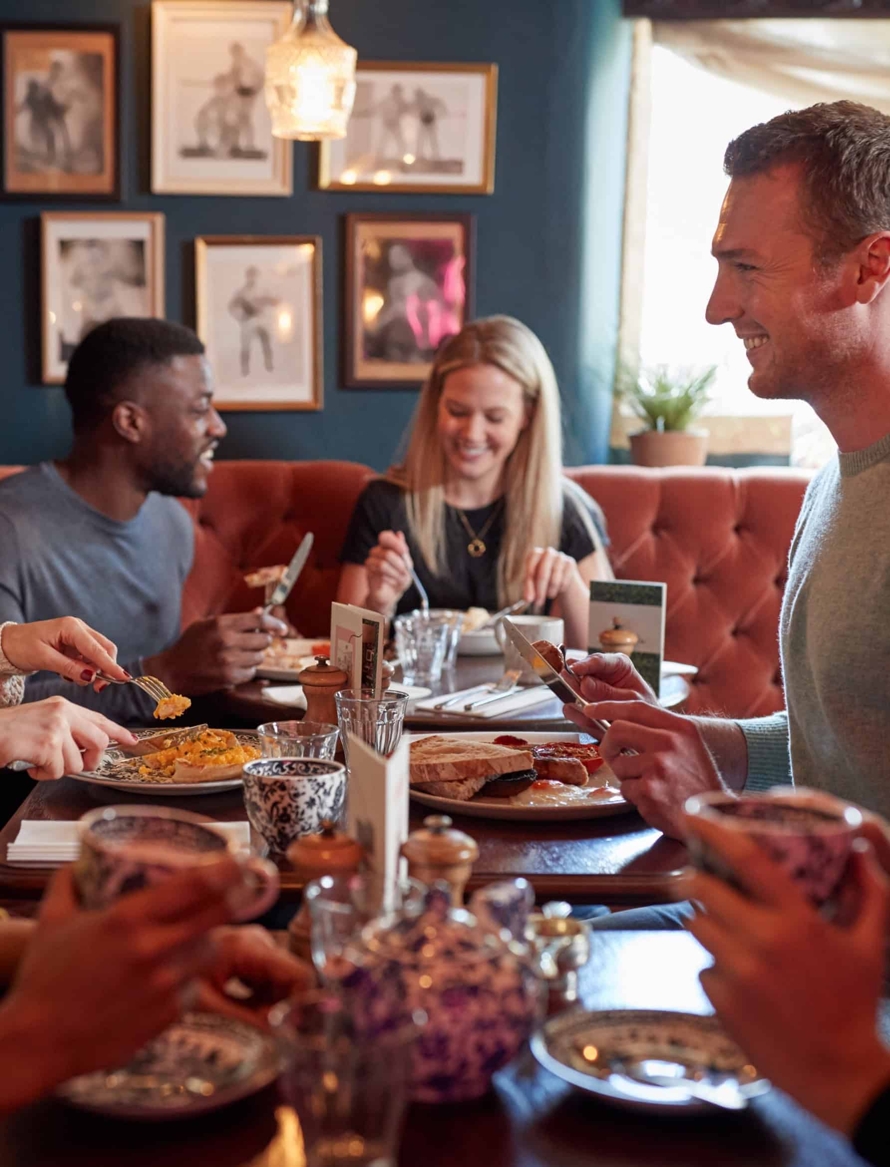 Group of friends dining at a full-service restaurant, illustrating restaurant leadership and consumer experience.